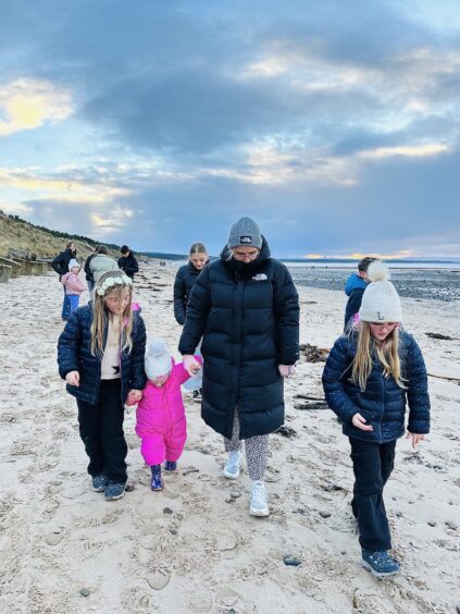 Zoe at the beach with her children.