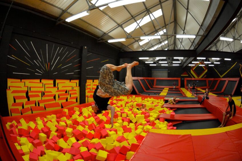 Someone diving into a soft play area at Infinity Trampoline,