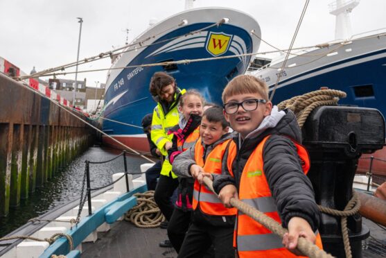 A group put their backs into raising the Reaper's sail. All images: Jamie Ross/DC Thomson