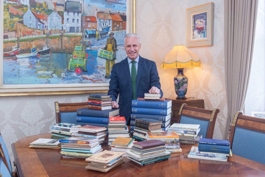 Robert Lovie with Robbie Shepherd's vast book collection.