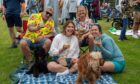 Image shows festivalgoers enjoying fun in the sun at 2024's Midsummer Beer Happening.