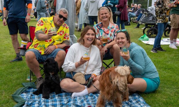 Image shows festivalgoers enjoying fun in the sun at 2024's Midsummer Beer Happening.