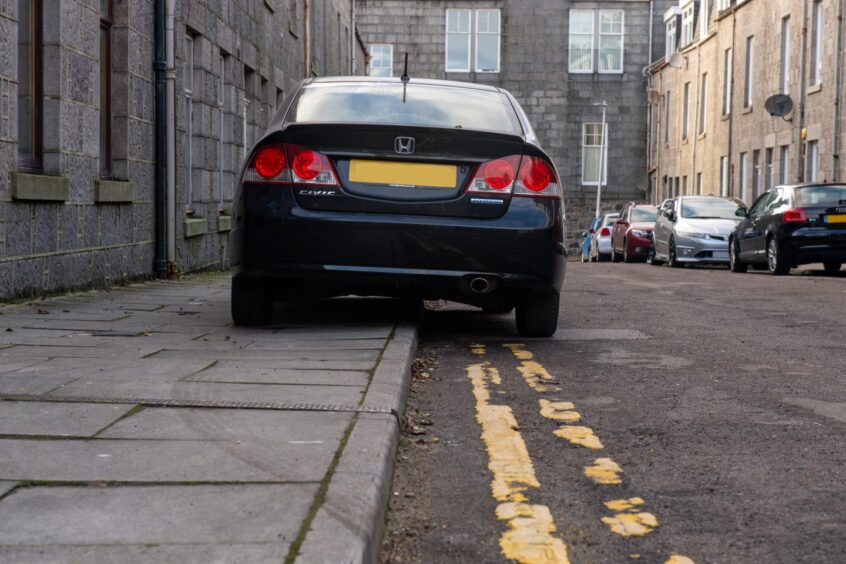 A car parked on a pavement in Aberdeen. 