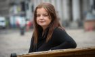 Victim of crime Sophie Corroon, 20, sits on a bench outside Aberdeen Sheriff Court