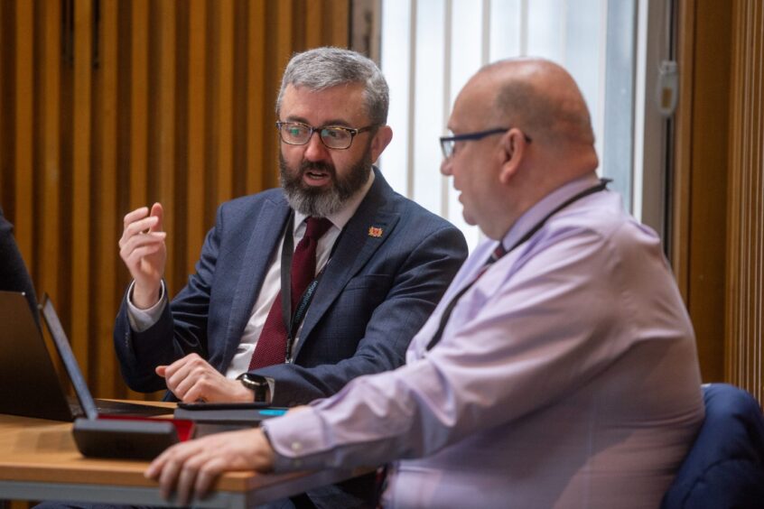 Chief planner David Dunne speaks to chief procurement officer Craig Innes in Aberdeen City Council chambers.