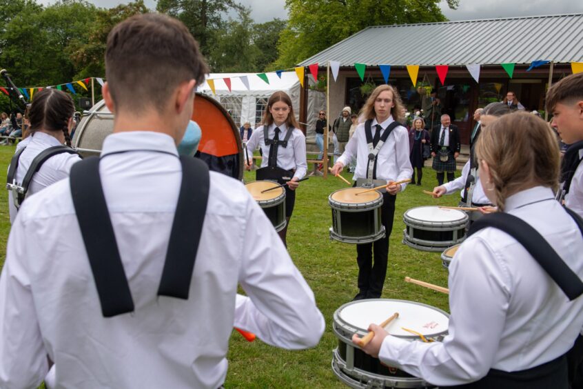 The Meldrum Academy Pipe Band play for the crowd.