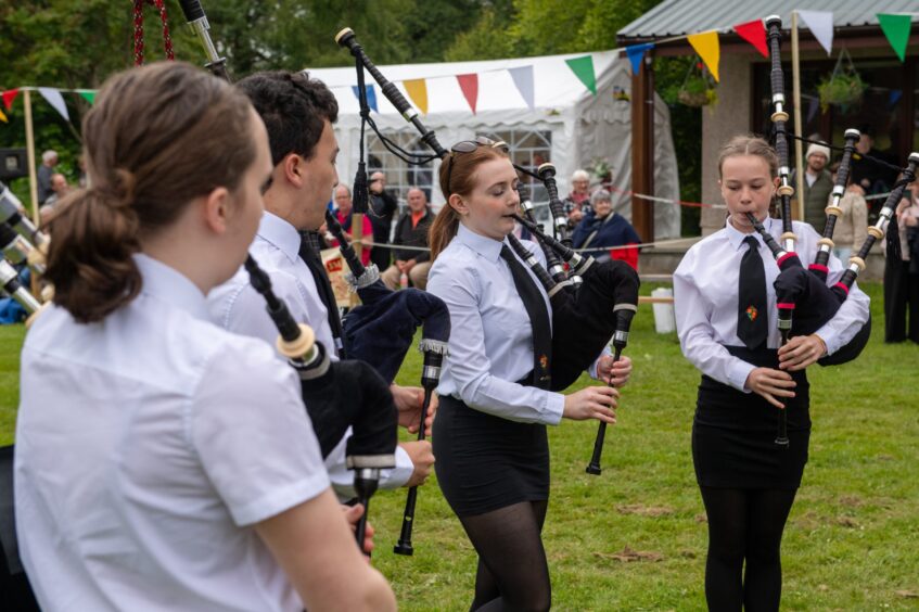 The Meldrum Academy Pipe Band play for the crowd.