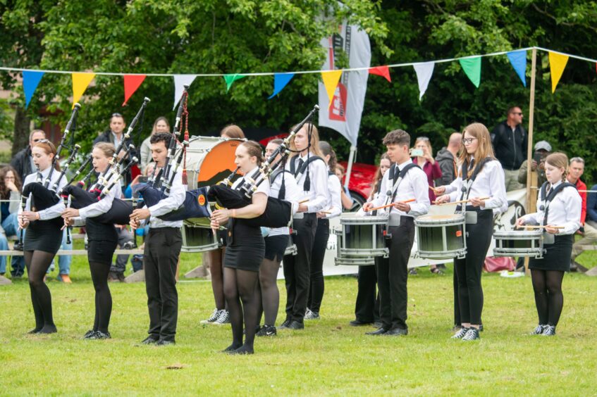 The Meldrum Academy Pipe Band play for the crowd.