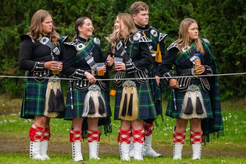 Pipe band members enjoying a drink. 