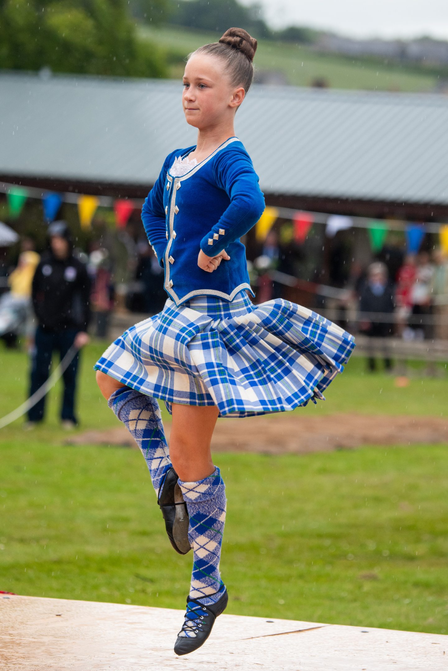 A young Highland dancer performing to the crowd. 