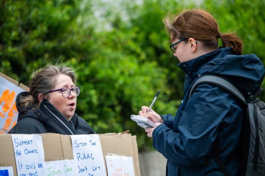 Torry Raac homeowner Janice Mackie speaks to reporter Kirstie Topp during a recent Torry Raac protest. 