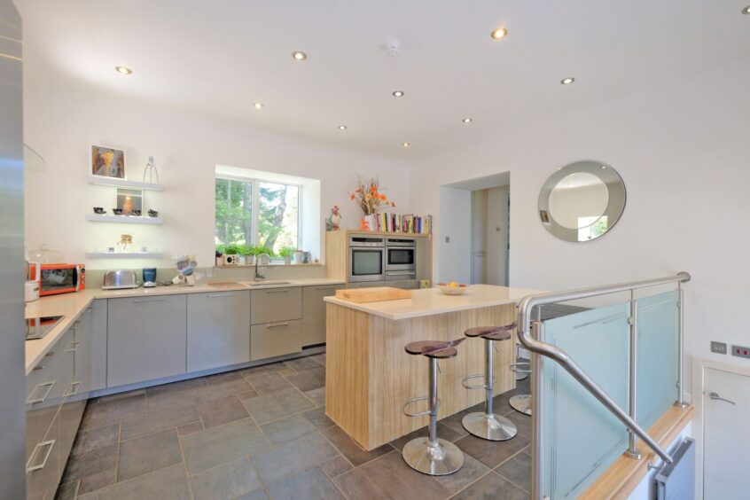 Modern kitchen with island unit incorporating a breakfast bar.