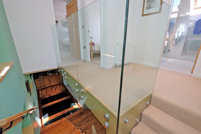 Cantilevered stairs with a glass support.