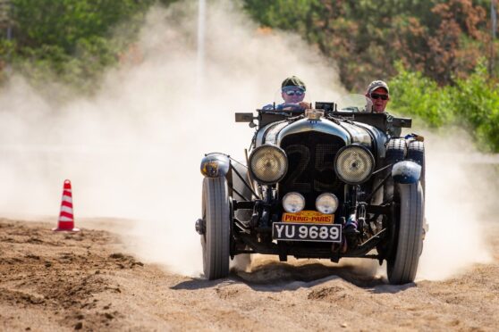 Peking to Paris vintage rally winners Andy Buchan and Mike Sinclair racing along in their car, Crunchie.