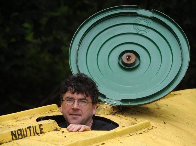 Stan's head popping out of his replica of the Nautile yellow submersible.
