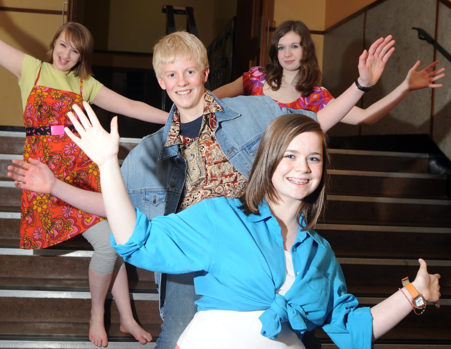 Four Inverurie Academy pupils posing for photos with jazz hands