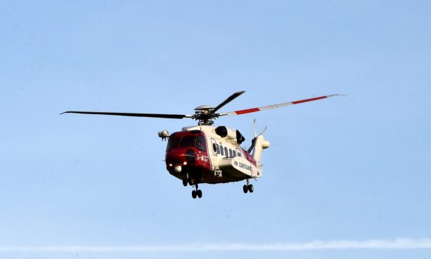 Coastguard rescue helicopter in the air.