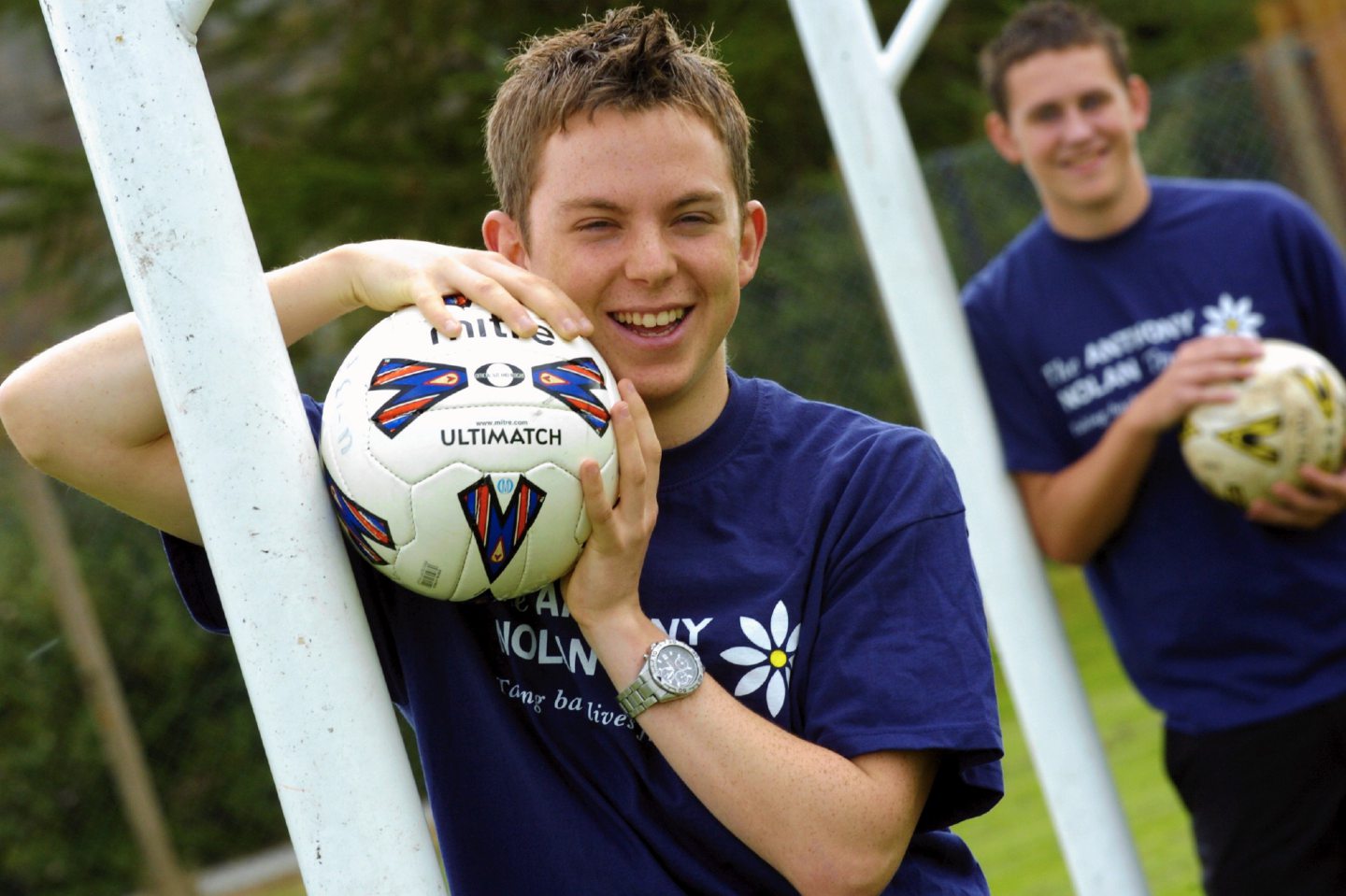 Two pupils holding footballs