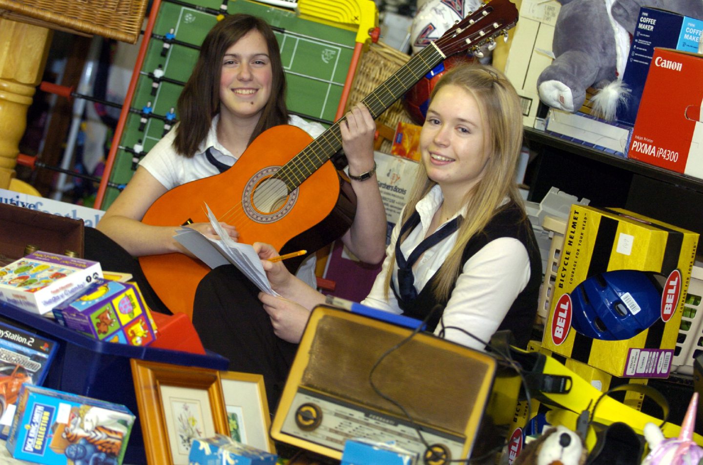 Inverurie Academy pupils posing with items set for auction for charity