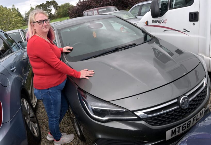 Michelle Clarke beside her grey Vauxhall Astra at Fearn Service Station in Tain.