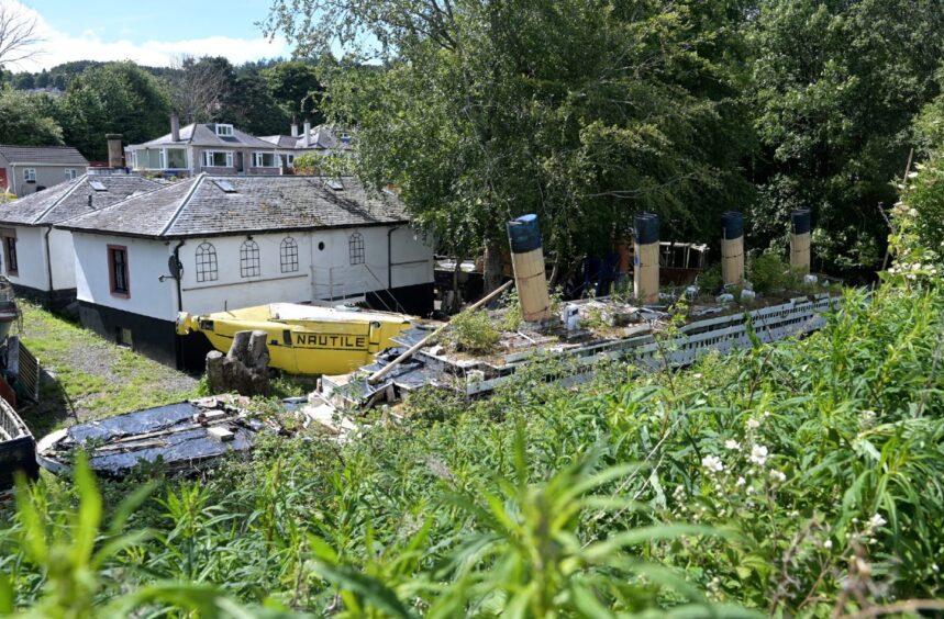 A wide view of STan's Ship Space museum, showing the decaying Titanic and Nautile.