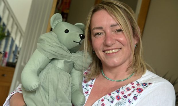 Andrea Robertson of West Craigs, Inverness - dressed in a white top with spots on the front- at work on one of her Memory Bears.