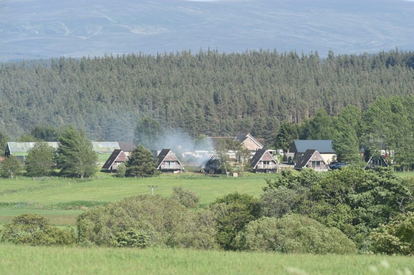 smoke can be seen coming from a chalet near Boat of Garten. 