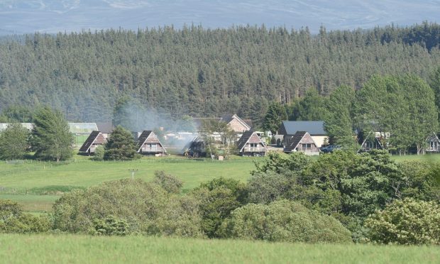 Smoke bellows from a chalet on fire near the Boat of Garten area.