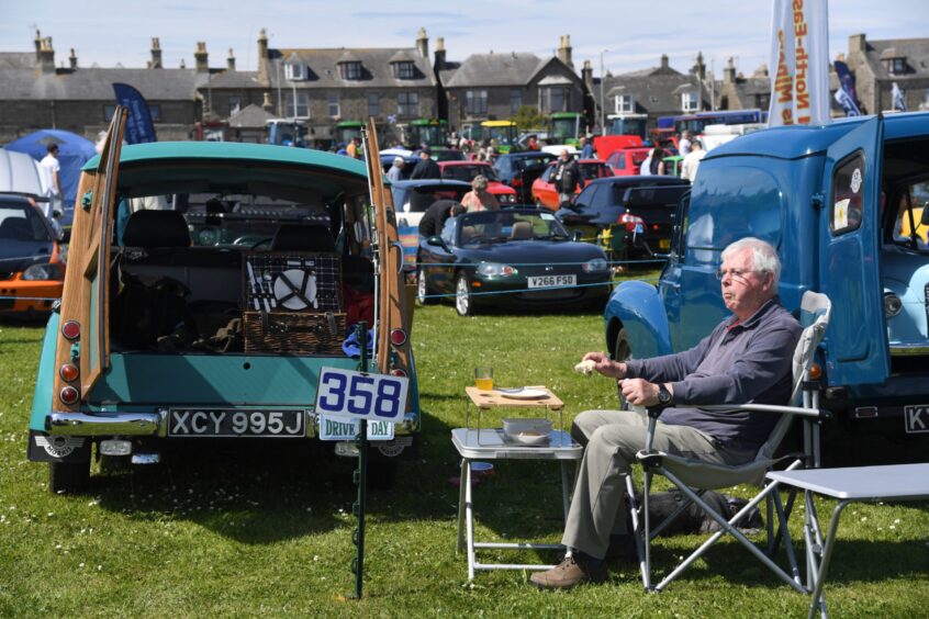 TIME FOR A SANDWICH IN THE BROCH SUNSHINE AT THE BACK OF A MORRIS MINOR TRAVELLER.