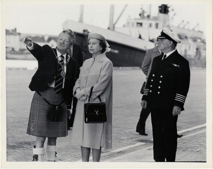 Provost Allan Sellar indicating interesting points of the new development at Inverness Harbour to the late Queen.