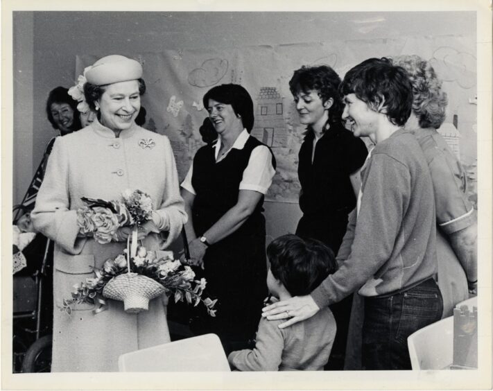 Queen Eliabeth chats with a group of mums in the children's ward at Raigmore Hospital in Inverness.