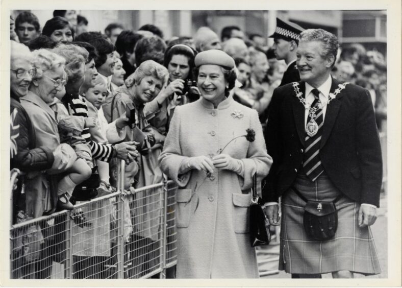Queen Elizabeth II walks along the crowd in Inverness town centre in 1985, accompanied by Provost Allan Sellar.