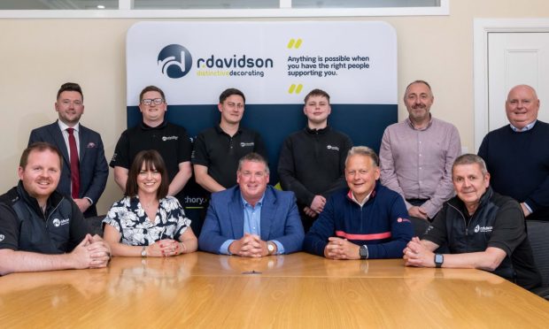 Trevor and Marianne Mutch with others who were involved in the sale of a 25% stake in R Davidson (Banchory)