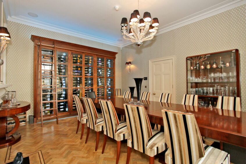 Dining room inside the Rubislaw Den South house, featuring large wine cabinet.