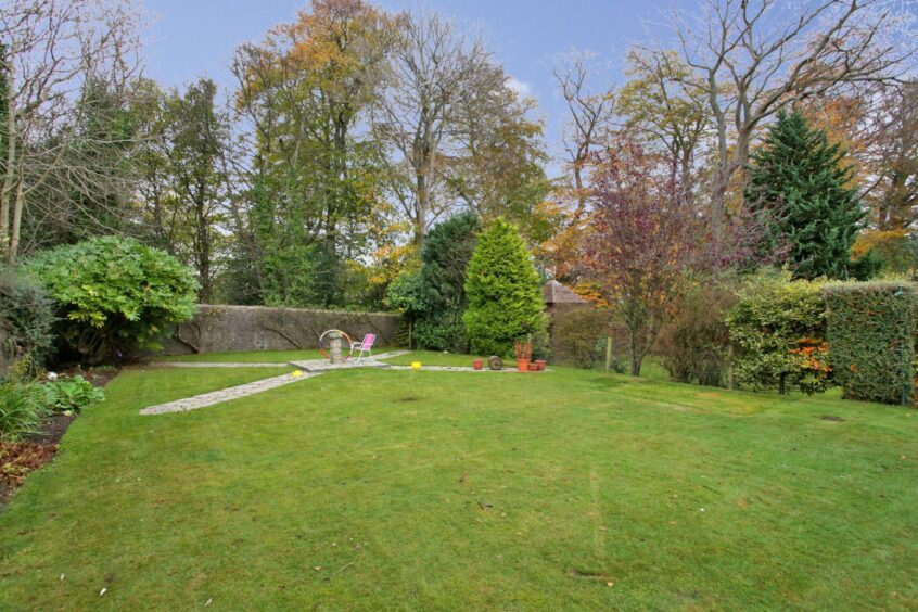 The enclosed back garden at 60 Rubislaw Den South with lawns, patios and a children’s play area.