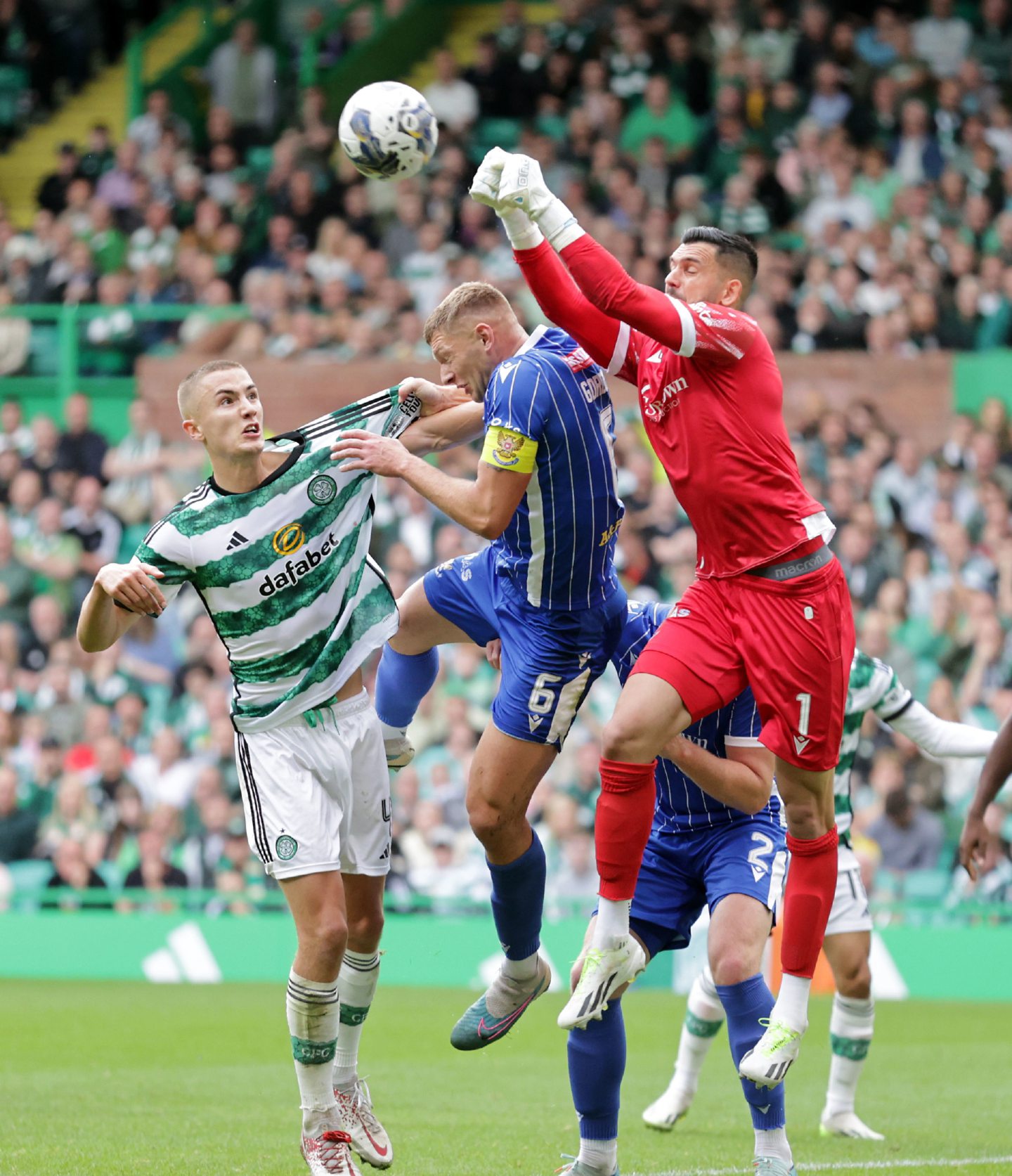 St Johnstone goalkeeper Dimitar Mitov attempts to punch the ball clear against Celtic. Image: PA 
