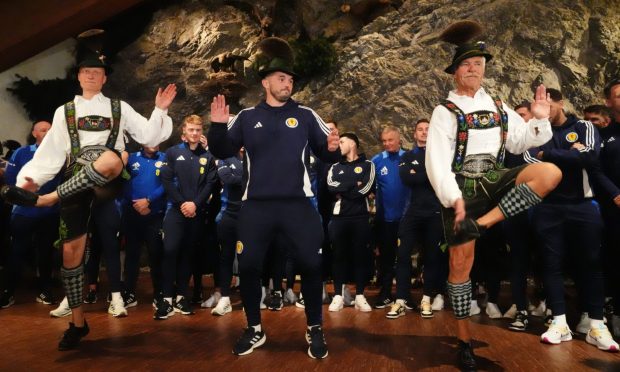 Scotland's John McGinn (centre) joins in with a dance as the team arrive at Bayernhalle in Garmisch-Partenkirchen, Germany, for a reception hosted by the Mayor. Image: PA.