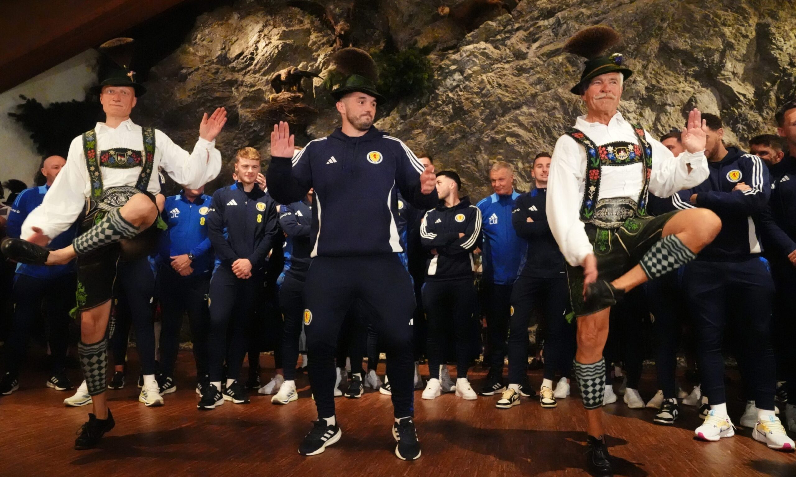 Scotland's John McGinn joins in with a dance as the team arrive at Bayernhalle in Garmisch-Partenkirchen, Germany, for a reception hosted by the mayor.