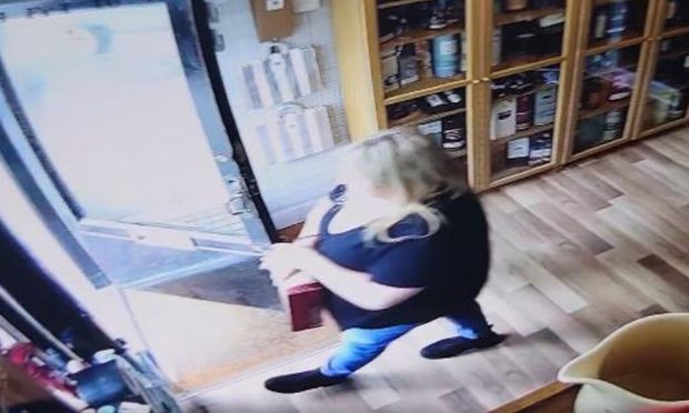 Woman leaving shop after stealing