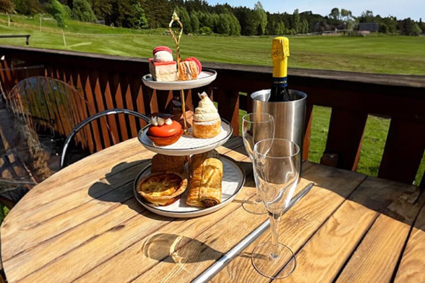 Afternoon tea spread on an outdoor terrace.
