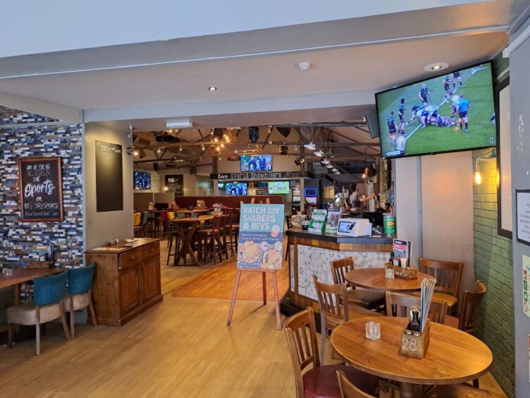 Live sports play on TV screens at Inverness pub The Auctioneers.