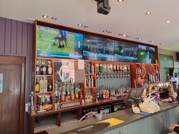 TV screens showing live sports inside The Imperial pub in Inverness.