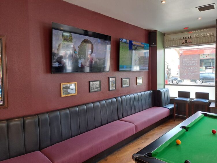 Pool table and TV screens inside the venue.