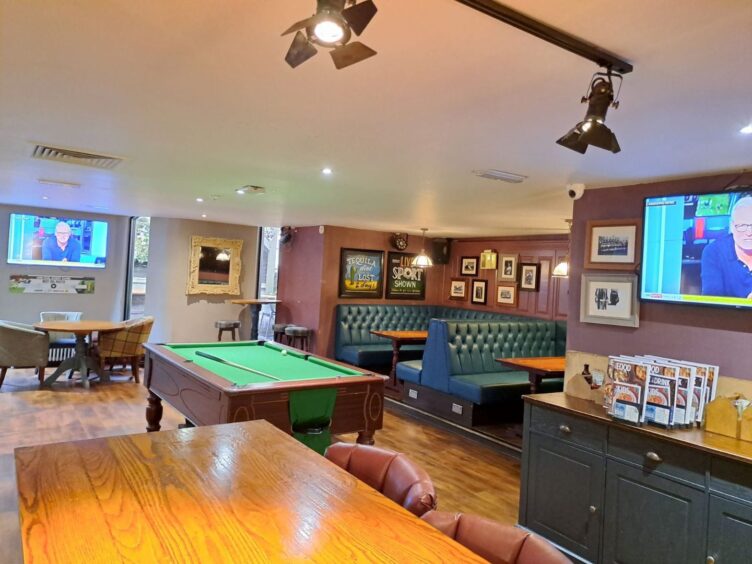 TV screens and pool table at the Inverness pub.