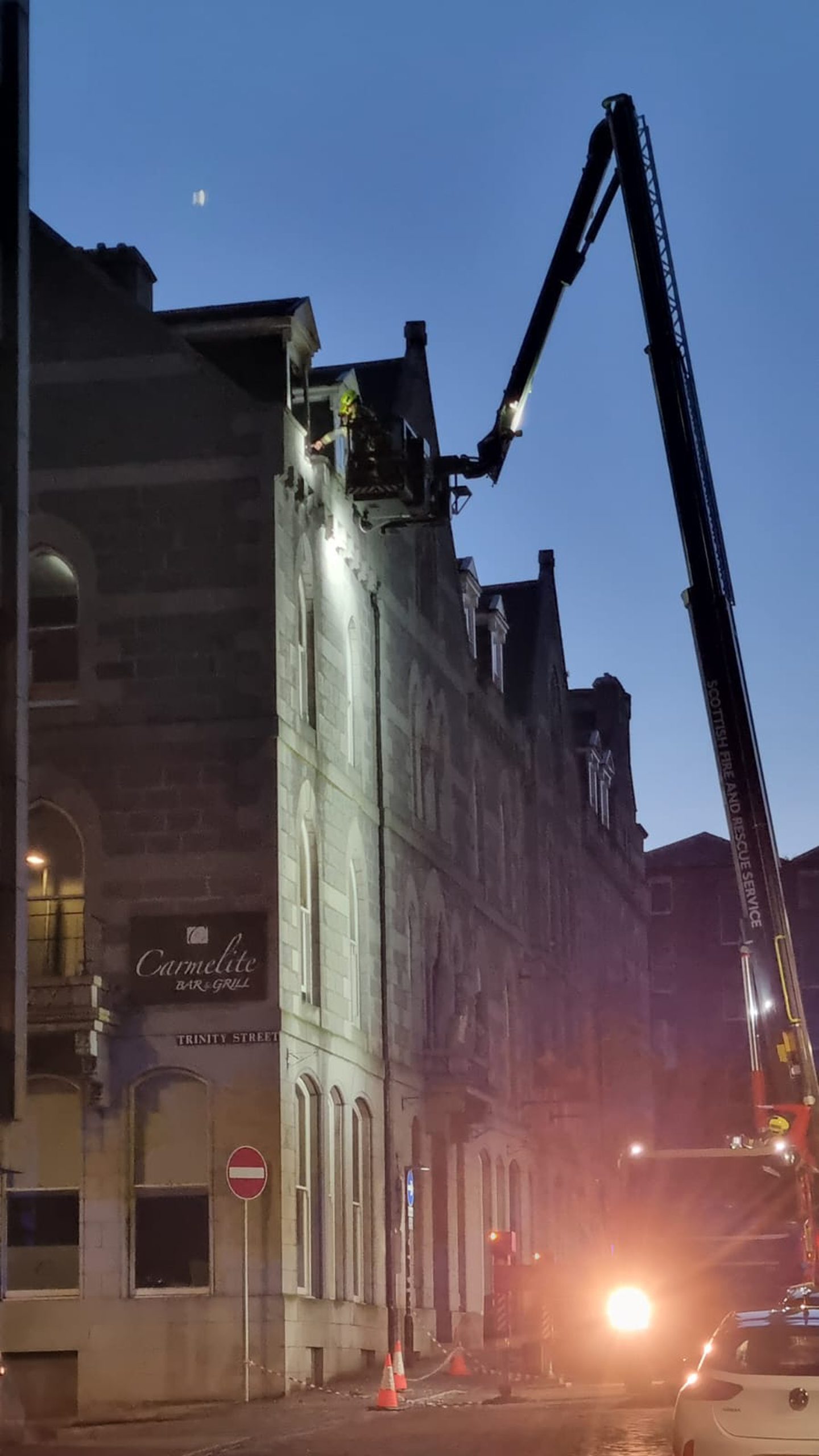 Firefighters using crane to enter room at Aberdeen's Carmelite hotel, where the fire started.