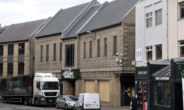 Black savers HGV sits outside the Botanic House venue in Inverness with the ground floor windows boarded up.