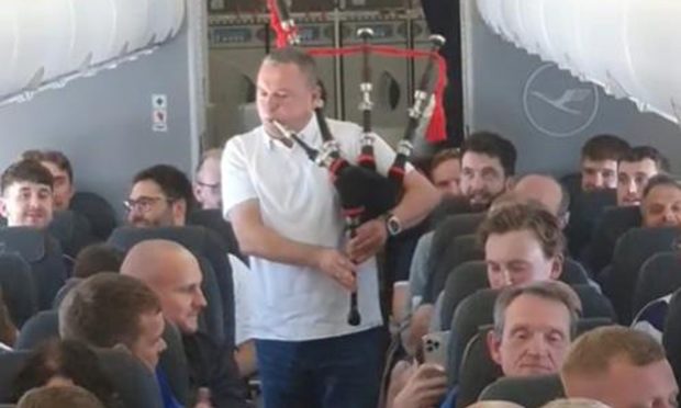 Passnegers cheers as their treated to a pipe solo en route to Munich. Image: Gully Singh.