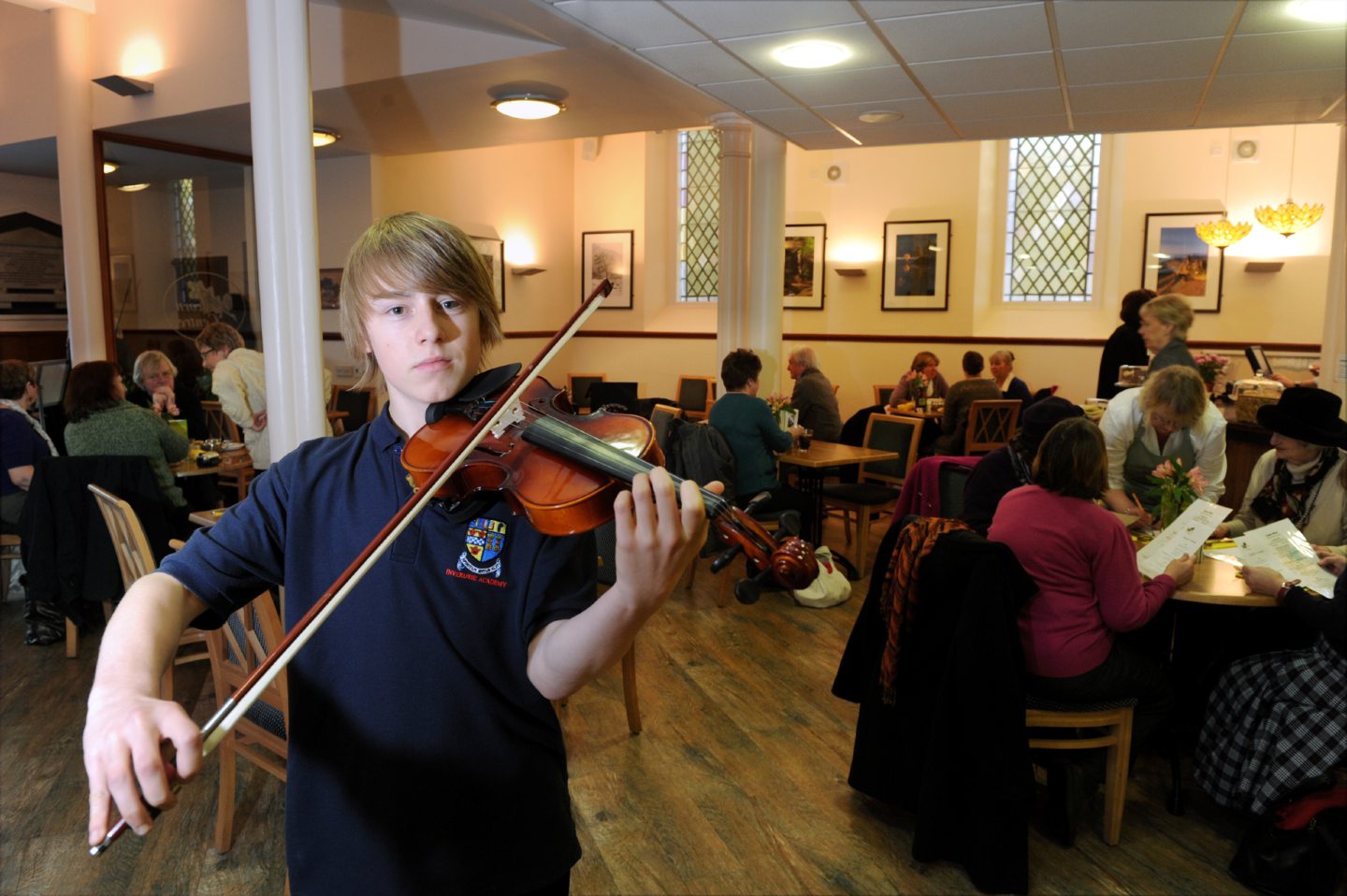 An Inverurie Academy pupil posing for photos while playing violin