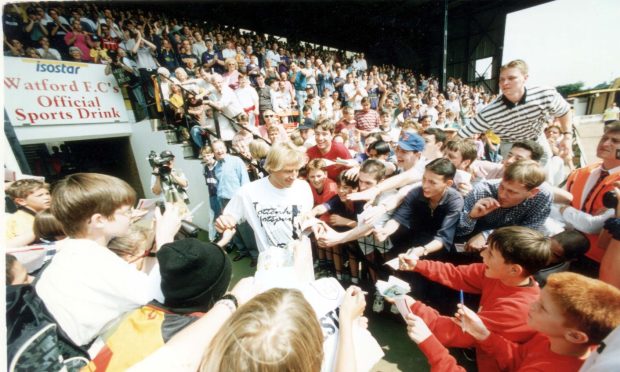 Jurgen Klinsmann signing autographs before his Tottenham debut against Watford in 1994. Image: Shutterstock.