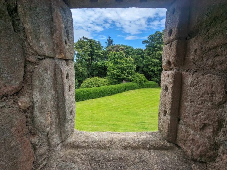 A view of the lavish parklands at Tolquhon Castle through a window. Image: Gayle Ritchie.